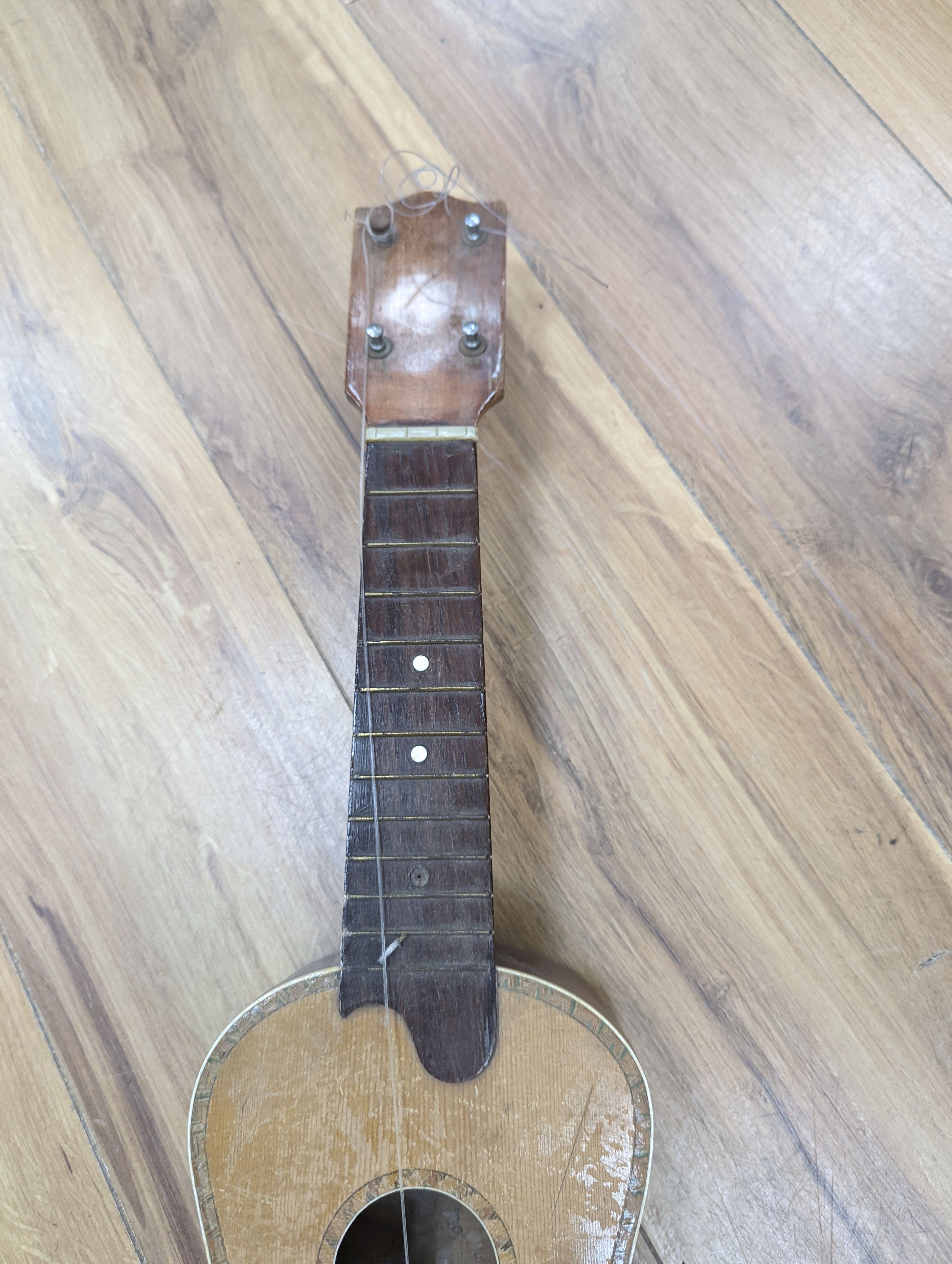 Four 3/4, half and quarter size violins and two ukuleles.